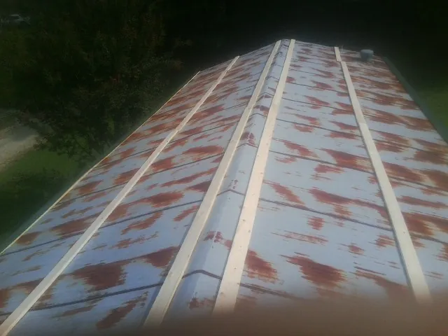 Rusted metal roof panels with new wood purlins before replacement — Storm Damage Roof Repair in Hamler by Roofing Brothers